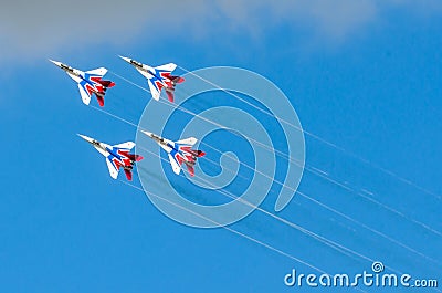 A group of four fighter aircraft in the blue sky with smoke. Russia. Moscow August 2015 Editorial Stock Photo