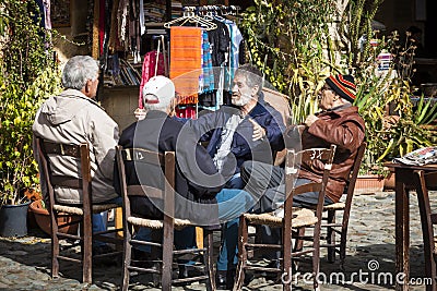 Group of four old male friends talking in city park Editorial Stock Photo