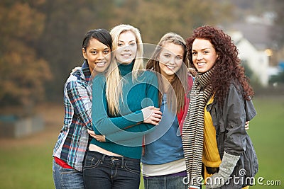 Group Of Four Teenage Girls In Autumn Landscape Stock Photo