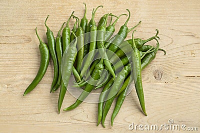 Group of fresh green chili peppers on wood Stock Photo