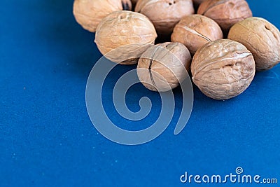 Group of wallnuts is on a blue background, healthy food concept Stock Photo
