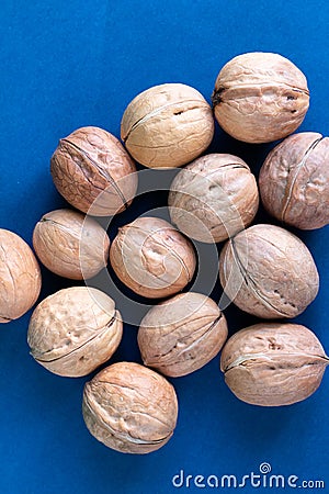 Group of wallnuts is on a blue background, healthy food concept Stock Photo