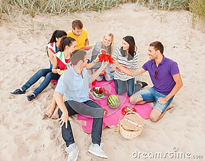 Group of friends celebrating birthday on beach Stock Photo