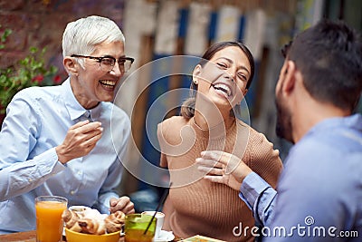 A group of friends of different generations having a good time while they have a drink in the bar. Leisure, bar, friendship, Stock Photo