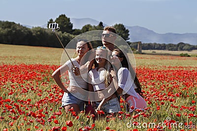 Group of friends doing a selfie in a field of poppies. Editorial Stock Photo