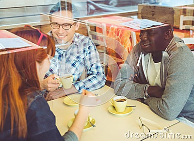 Group of friends drinking coffee in a bar Stock Photo