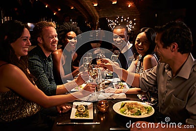 Group Of Friends Enjoying Meal In Restaurant Stock Photo