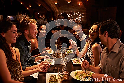 Group Of Friends Enjoying Meal In Restaurant Stock Photo