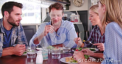 Group Of Friends Enjoying Meal In Restaurant Together. Group of friends sitting around table at rooftop restaurant.Shot in 4k on Sony FS700 at frame rate of stock video Group Of Friends Enjoying Meal In Restaurant Together. Group of friends sitting around table at rooftop restaurant.Shot in 4k on Sony FS700 at frame rate of stock video