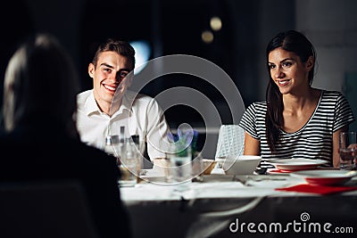 Group of friends having a dinner in a restaurant.Double date.Attractive people night out,dining in a hotel.Trendy people Stock Photo