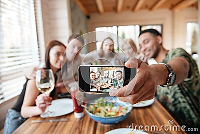 Group of friends having dinner and taking selfie with smartphone Stock Photo