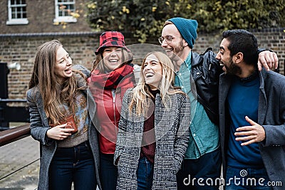 Group on friends having fun around the city in winter time - Focus on center girl face Stock Photo