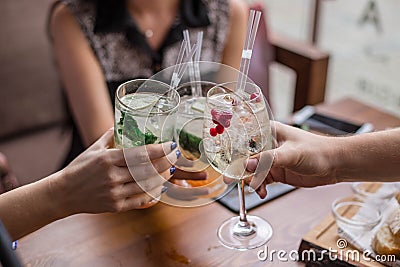 Group of friends having fun and drink cocktails. Stock Photo