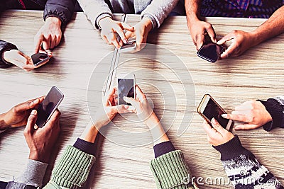 Group of friends having fun together with smart phones - Hands social networking with mobile device - Technology and phone Stock Photo