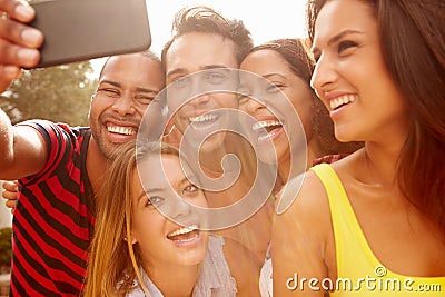 Group Of Friends On Holiday Taking Selfie With Mobile Phone Stock Photo