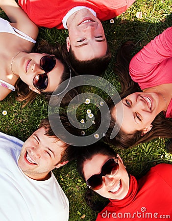 Group of friends lying on grass looking up Stock Photo