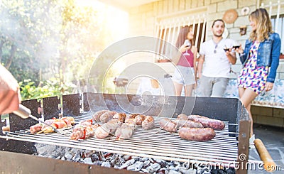Group of friends making a barbecue in the backyard garden Stock Photo