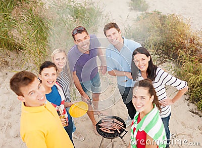 Group of friends making barbecue on the beach Stock Photo