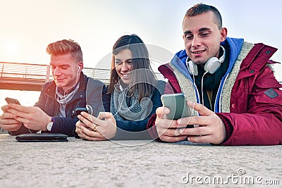 Group of friends playing with their smartphones Stock Photo