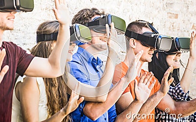 Group of friends playing on virtual reality vr goggles Stock Photo