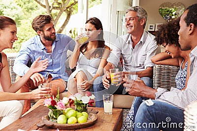 Group of friends socialising in a conservatory Stock Photo