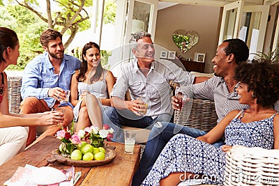 Group of friends socialising in a conservatory Stock Photo
