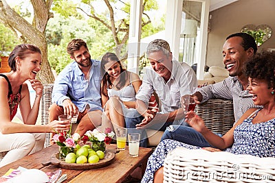 Group of friends socialising in a conservatory Stock Photo