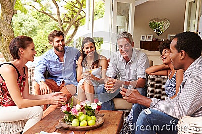 Group of friends socialising in a conservatory Stock Photo