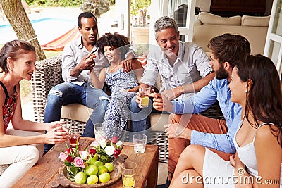 Group of friends socialising in a conservatory Stock Photo