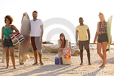 Group of friends standing and looking at camera at beach on a sunny day Stock Photo