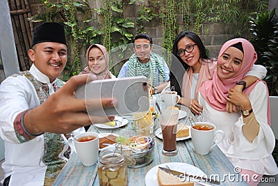 Group of friends taking selfie during lunch outdoor Stock Photo