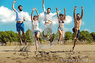 Group of friends together on the beach having fun. Stock Photo