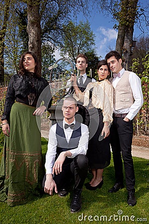 Group friends in Victorian clothing in park Stock Photo