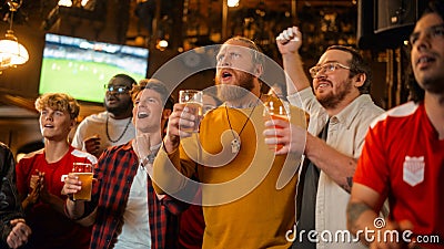 Group of Friends Watching a Live Soccer Match on TV in a Sports Bar. Three Men Cheering and Shouting Stock Photo