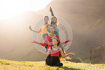 A group of girls meditate at sunset Stock Photo