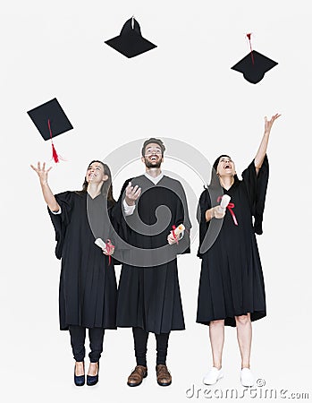 Group of grads throwing their hats in the air Stock Photo