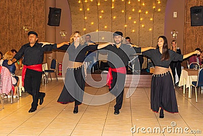 A group of Greek dancers performing at arestaurant Editorial Stock Photo