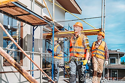 group of handsome builders working together Stock Photo