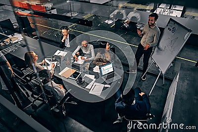 A group of handsome business people working in a spacious conference room in a large business center. Concept of startup, projects Stock Photo