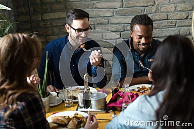 Group of happy business people eating in restaurant Stock Photo