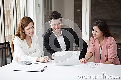 Group of happy business people men and woman working together on laptop in meeting room.teamwork of two girl asian and caucasian Stock Photo