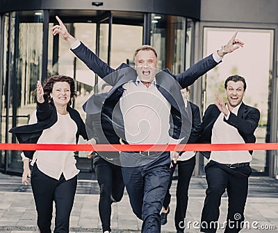 Business people crossing the finish line Stock Photo