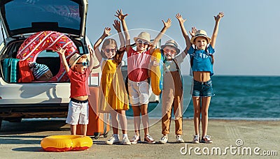 Group happy children girls and boys friends on the car ride to summer trip Stock Photo