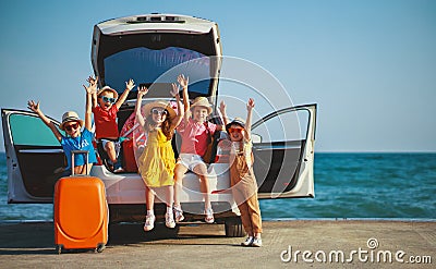 Group happy children girls and boys friends on car ride to summer trip Stock Photo