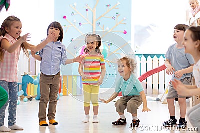 Group of happy children jump indoor. Kids play together Stock Photo