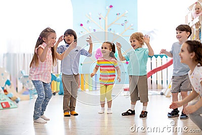 Group of happy children jump in club. Kids playing together Stock Photo