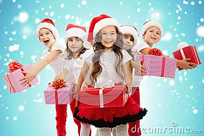 Group of happy kids in Christmas hat with presents Stock Photo