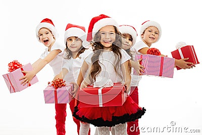 Group of happy kids in Christmas hat with presents Stock Photo