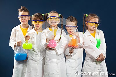 Group happy kids doing science experiments in the laboratory. Stock Photo