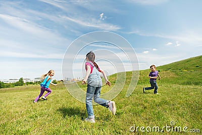 Group of happy kids running outdoors Stock Photo